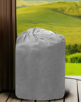 An Insulated Pump Cover For Egg Pump, Depicted By a Grey Trash Bag On a Wooden Floor