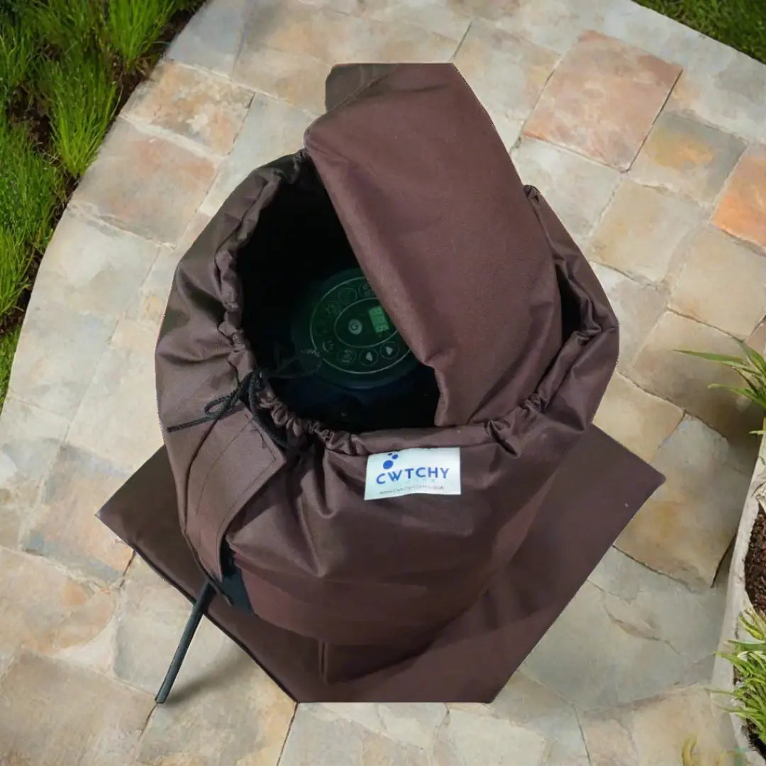 A Brown Hat On a Stone Floor With An Insulated Pump Cover For Egg Pump