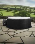 Wave Spa Insulated Hot Tub With Black Cover On Stone Patio, Designed For Wavespa Atlantic